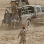 Two U. S. Soldiers, assigned to 3-319 Field Artillery Regiment, 1st Brigade Combat Team, 82nd Airborne Division, ride along with a group of Iraqi soldiers from the 27th Iraqi Army Brigade, in Dulab, Iraq, Oct. 20, 2009. The 27th IA conducted a ceremony to demonstrate its tactical capabilities.<br /><em>Credits: 1st Brigade Combat Team, 82nd Airborne Division Public Affairs , 10/20/09, Location: Al Asad Airbase, Iraq</em> Iraqi Operation