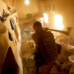 A solider with Combined Anti Armor Team 1, 1st Battalion, 5th Marine Regiment, uses an axe to break open a hidden compartment after discovering illegal drugs and improvised explosive device making material while searching a compound in Nawa District, Helmand province, Afghanistan, Oct. 19, 2009. CAAT 1 and Marines with Weapons Company, 1/5, conducted a two day operation to clear out local villages known to be used by enemy insurgents and to rid commonly traveled roads of IED's.<br /><br />The cache consisted of weapons, more than 1,000 rounds of ammunition, 50 pounds of heroin, cocaine, homemade explosives and IED-making materials.<br /><em>Credits: 1st Marine Division, 10/19/09</em> Searching for Contraband and weapons