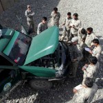 U.S. Army Soldiers teach a group of Afghan Border Policemen how to perform basic maintenance on their police trucks during training on Combat Outpost Herrera, Paktiya province, Afghanistan, Oct. 6, 2009. These ABP are students in a partnership training program called the Combined Action Academy. The CAA is a four week program that uses a platoon of Soldiers from Apache Troop, 1st Squadron, 40th Cavalry Regiment to teach the ABP basic Soldier skills including discipline, team work, patrolling and culminates with a live fire exercise.<br />Credits: Combined Joint Task Force - 82 PAO, 10/6/09 Afghan Border Policemen