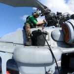 Aviation Structural Mechanic Airman services a rotor head on a MH-60S Seahawk helicopter on the flight deck of the multi-purpose amphibious assault ship USS Wasp (LHD 1). WASP is currently deployed on Southern Partnership Station-Amphib with Destroyer Squadron 40 and a Security Cooperation Marine Air Ground Task Force embarked. <br />Credits: Navy Public Affairs Support Element - East , 10/16/09, Location: Caribbean Sea Servicing the Rotor Head