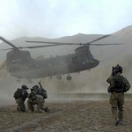 Soldiers of the joint force brace themselves against the CH-47's rotor wash at the HLZ, Zanakhan District, Ghazni Province, Afghanistan.<em>Credit: 55th Combat Camera, Photo by Spc. Walter Reeves, 10/31/09, Location: Zanakhan District, Afghanistan</em> CH47 Rotorwash