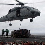 SH-60F Sea Hawk helicopter assigned to the Chargers of Helicopter Anti-Submarine Squadron (HS) 14 lifts cargo from the aircraft carrier USS George Washington (CVN 73) to the Military Sealift Command fleet replenishment oiler USNS Rappahannock (T-AO 204). George Washington, the Navy's only permanently forward deployed aircraft carrier, is underway supporting security and stability in the western Pacific Ocean.<em>Credit: Navy Visual News Service, 11/5/09</em> Cargo Lift at Sea