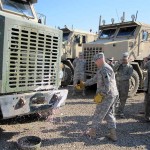 Col. C.J. Read, the commander of the 96th Sustainment Brigade, 13th Sustainment Command (Expeditionary), dedicates the first Heavy Equipment Transport to come out of the intensive maintenance program of the 1st Maintenance Company, 260th Combat Sustainment Support Battalion, 96th SBDE, 13th ESC, by breaking a glass bottle on the bumper of the vehicle. The mechanics of the 1st Maintenance Company established an extensive maintenance and service program to improve the maintenance posture of these heavy vehicles, ensuring that they are fully mission-capable to support the logistical efforts throughout Iraq. <br /><em>Credit: 12/8/09, Location: CAMP LIBERTY, Iraq</em> Commander Dedicates Vehicle