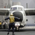 An aircraft director guides a C-2A Greyhound aircraft safely across the flight deck upon completion of daily flight operations aboard the Nimitz-class aircraft carrier USS Harry S. Truman. <br /><em>Credit: US Navy Visual News Service, 11/8/09</em> Greyhound Lands