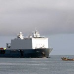 A local fishing vessel passes by the Dutch navy amphibious ship HNLMS Johan De Witt L 801 as the ship prepares to enter port. Johan De Witt is in Sierra Leone for a two day port visit to deliver medical and relief supplies to hospitals in Tunguma and Lungi. Johan De Witt, a Royal Dutch naval vessel, is the first European led Africa Partnership Station platform and is augmented by staff from Belgium, Portugal and the U.S.<br /><em>Credits: USN Visual Service, 10/17/09</em> Dutch Warship in Humanitarian Support Operations