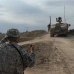 U.S. Soldiers of the 30th Heavy Brigade Combat Team, 1st Cavalry Division, help direct a High Mobility Multipurpose Wheeled Vehicle back down a road during an Improvised Explosive Device search near Combat Outpost Meade, Baghdad, Iraq. U.S. Soldiers of the 30th HBCT gained intelligence about the whereabouts of an IED, and sent a patrol out to confirm its existence. <br /><em>Credit: 12/5/09, Location: Baghdad, Iraq</em> IED Search
