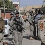 <p>Sgt. Richard Goley (center), of Charlotte, N.C., walks down a neighborhood street in the Rashid District in southern Baghdad during a mission with Soldiers of 6th Iraqi Army, Nov. 7.</p><p>During a joint U.S. / Iraqi foot patrol, Nov. 7, the dismounted security patrols through vacant buildings are all in a day's work. This is familiar ground; the U.S. Soldiers have done more than 100 patrols and trained many of the ISF who went out on the day's mission. The area is urban, mixed apartments, small shops and houses. The convoy pulls up to a tree-shaded road with several multi-story houses and apartments. </p><p>The Soldiers must balance the war fighter and the neighbor."You can show you mean business but also show an interest in their problems like water, infrastructure, even the weather," said one American solider. </p><p><em>Credit: 30th Heavy Brigade Combat Team, 11/7/09</em></p> Iraqi Stability Operations