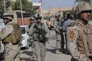 <p>Sgt. Richard Goley (center), of Charlotte, N.C., walks down a neighborhood street in the Rashid District in southern Baghdad during a mission with Soldiers of 6th Iraqi Army, Nov. 7.</p><p>During a joint U.S. / Iraqi foot patrol, Nov. 7, the dismounted security patrols through vacant buildings are all in a day's work. This is familiar ground; the U.S. Soldiers have done more than 100 patrols and trained many of the ISF who went out on the day's mission. The area is urban, mixed apartments, small shops and houses. The convoy pulls up to a tree-shaded road with several multi-story houses and apartments. </p><p>The Soldiers must balance the war fighter and the neighbor."You can show you mean business but also show an interest in their problems like water, infrastructure, even the weather," said one American solider. </p><p><em>Credit: 30th Heavy Brigade Combat Team, 11/7/09</em></p>