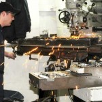 <p>Petty Officer 3rd Class David Manders, machinery repariman, uses a "fly cutter" to level out a base for the milling machine in USS Wasp's Machine Repair shop. Manders and his fellow MR shop workers are in charge of repairing vital parts of the ship when they need to be fixed. Wasp is currently deployed on Southern Partnership Station-Amphib with Destroyer Squadron 40 and embarked SCMAGTF. Southern Partnership Station is part of the Partnership of the Americas Maritime Strategy that focuses on building interoperability and cooperation in the region to meet common challenges.</p><p>"We are the emergency repair shop for the ship," said Machinery Repairman 1st Class (SW/AW) Isaiah Dennison, MR shop leading petty officer. "We fix pumps, motors, valves and many other items. We also run the ship's engraving and locksmith shops."</p><p><em>Credit: USS WASP, 11/23/09</em> Maintaining the Wasp