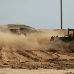 An Airman of the 732nd Expeditionary Civil Engineer Squadron stockpiles dirt with a bulldozer during construction of a new container repair yard, Nov. 2. By using containers repaired here instead of purchasing new ones, the projected savings total more than $100 million as military assets withdraw from Iraq.<em>Credit: 332nd Air Expeditionary Wing, Photo by Senior Airman Chris Hubenthal, 11.02.2009</em><br />Posted: 11.09.2009 03:32<br />Photo ID: 221667<br />VIRIN: 091102-F-6304H-096<br />Location: IQ Repairing a Container Yard in Iraq