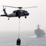 An MH-60S Sea Hawk helicopter assigned to Helicopter Sea Combat Squadron (HSC) 23 delivers cargo aboard the flight deck of the Military Sealift Command fast combat support ship USNS Bridge (T-AOE 10) during a vertical replenishment with the Bonhomme Richard Amphibious Ready Group. The Bonhomme Richard ARG is supporting maritime security operations in the U.S. 5th Fleet area of responsibility.<em>Credit: Navy Visual News Service, 11/11/09, Location: GULF OF OMAN, At Sea</em> Sea Hawk Helo in Support Operation