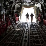 Right, Airman 1st Class Dustin Wiley and Senior Airman Brandon Owens, 379th Expeditionary Security Forces Squadron Fly Away Security Team members, exit a C-130 as they prepare to secure the area around the aircraft, Oct. 6, in Southwest Asia. Airmen Wiley and Owens ensure U.S. Air Force aircraft are secure when they travel to areas with less established security. Airman Wiley is deployed from RAF Mildenhall, England, and Airman Owens is from Bolling Air Force Base, Washington D.C. Both are deployed in support of Operations Iraqi and Enduring Freedom.<br /><em>Credits: 379th Air Expeditionary Wing, 10/6/09, Location: Southwest Asia </em> Securing C-130