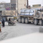 <p>A U.S. military cargo truck, called a Palletized Load System, rolls through Kandahar City while carrying lumber for forward operating base expansion in Helmand. The 286th Combat Support Sustainment Battalion runs regular convoys to FOBs throughout Southern Afghanistan.</p><p>Besides moving materials for tents, buildings and perimeter fortifications by military cargo trucks, called Palletized Load System vehicles, troops under the 286th CSSB also provide convoy security through armored gun trucks, called Mine-Resistant, Ambush-Protected vehicles.</p><p>Convoys face multiple dangers from roadside bombs, rocket-propelled grenades, small-arms fire and vehicle-born improvised explosive devices. The MRAPS and PLS trucks roll through Afghan towns and cities while local traffic races in and around the convoy.</p><p><em>Credit: Joint Sustainment Command - Afghanistan , 11/24/09</em> Soldiers Convoy Building Materials