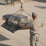 Spc. Gary Newman, a Combat Repair Team 1 wrecker operator with the 402nd Brigade Support Battalion, guides the hatch door of a Stryker to the ground at the motor pool on Forward Operating Base Ramrod, Afghanistan. At Ramrod, the task of repairing not only Strykers but all the vehicles attached to the 2nd Battalion, 1st Infantry Regiment, falls to the team of mechanics and other repairmen from Combat Repair Team 1, 402nd Brigade Support Battalion. <br /><em>Credit: 22nd Mobile Public Affairs Detachment , 11/18/09</em> Stryker Mechanic