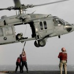 Aviation Ordnancemen aboard the Nimitz-class aircraft carrier USS Dwight D. Eisenhower (CVN 69) hook securing lines onto an MH-60S Sea Hawk helicopter during a weapons onload. Eisenhower is conducting a three-week composite training unit exercise in preparation for an upcoming 2010 deployment.<em>Credit: Navy Visual News Service, 11/11/09, Location: ATLANTIC OCEAN, At Sea</em> Weapons Onload