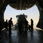 A CH-46 Helicopter one of the largest Helos in the USN inventory being loaded into the rear of a C-5 heavy lift transport. The C-5 can load front and rear as well as taking transport troops on the top deck to carry a full complement of gear and troops for ready deployment. <br />Credit: Lockheed Martin Corporation Loading a CH-46 Helicopter