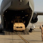 A U.S. Air Force C-17 Globemaster III loadmaster spots the driver of a Mine-Resistant, Ambush-Protected All-Terrain Vehicle as he drives it off the aircraft, Oct. 1. The M-ATV's are the first of their kind in Afghanistan and support small-unit combat operations in highly restricted rural, mountainous and urban environments that include mounted patrols, reconnaissance, security, convoy protection, communications, command and control, and combat service support. Transporting a load of M-ATVs by U.S. Air Force aircraft can be accomplished in a day, where sealift would require approximately 26 days. An order for more than 6,600 of the M-ATVs are expected to be fielded over the next year. Three M-ATVs were loaded onto a C-17 Globemaster III and four onto a C-5 Galaxy at Charleston AFB, S.C., Sept. 29, and flown to Afghanistan. The M-ATV It is designed to replace the up-armored Humvee in Afghanistan. The M-ATV will carry up to five personnel: four plus a gunner. The C-17 is from McChord Air Force Base, Wash. and was operated by a crew from Charleston AFB, S.C. <br />Credit US Air Forces Central Public Affairs 10/1/09 Mine-Resistant, Ambush-Protected All-Terrain Vehicle