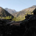 An Afghan national army soldier scans the surrounding area while on patrol with U.S. Marines assigned to Embedded Training Team 7-5 in Kunar province, Afghanistan's Korengal Valley, Sept. 29. ETT's across Afghanistan serve as mentors to the emerging Afghan military. Credit: Combined Joint Task Force, 82 PAO 9/29/09 Afghan national army soldier