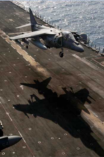 An AV-8B Harrier assigned to Marine Medium Tiltrotor (VMM) 162 (Reinforced) participates in a hover exercise off the flight deck of the amphibious assault ship USS Nassau (Credit photo: USN Visual Service, 3/21/10) An AV-8B Harrier assigned to Marine Medium Tiltrotor (VMM) 162 (Reinforced) participates in a hover exercise off the flight deck of the amphibious assault ship USS Nassau (Credit photo: USN Visual Service, 3/21/10)