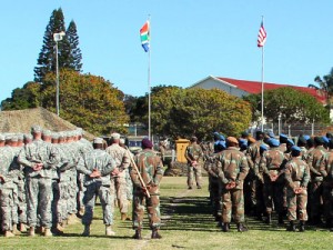 Service members with the U.S. and South African militaries stand in formation during the opening ceremony of Exercise Shared Accord 13 in Port Elizabeth, South Africa. Shared Accord is a biennial training exercise which promotes regional relationships, increases capacity, trains U.S. and South African forces, and furthers cross-training and interoperability. Credit: US Army