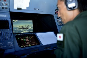 A member of the Japan Air Self Defense Force observes Royal Australian Air Force KC-30A crews refuel RAAF F/A-18's while participating in Cope North 13 near Anderson Air Force Base, Guam, Feb. 13, 2013. Cope North is an annual air combat tactics, humanitarian assistance and disaster relief exercise designed to increase the readiness and interoperability of the U.S. Air Force, Japan Air Self-Defense Force and Royal Australian Air Force. (U.S. Air Force photo by Senior Airman Matthew Bruch/Released). 2/12/13