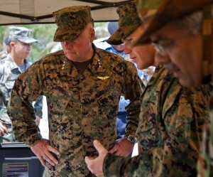 U.S. Marine Sgt. Robert W. Walker, center, explains the capabilities of the miniature deployable assistance water purification system to U.S. Marine Lt. Gen. Terry G. Robling at a disaster site in Biang, Brunei Darussalam, June 19 as part of the Association of Southeast Asian Nations Humanitarian Assistance/Disaster Relief and Military Medicine Exercise (AHMX). The disaster site is the location of the field training exercise portion of the multilateral exercise, which provides a platform for regional partner nations to address shared security challenges, strengthen defense cooperation, enhance interoperability and promote stability in the region. Robling is the commanding general of U.S. Marine Corps Forces, Pacific. Walker is an engineer equipment electrical systems technician with 9th Engineer Support Battalion, 3rd Marine Logistics Group, III Marine Expeditionary Force. 6/19/13