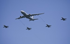 Four F/A-18A Hornets from No. 3 Squadron (SQN) perform a mock air to air refuelling pass with a No. 33 SQN KC-30A Multi Role Tanker Transport aircraft. This flight demonstration was performed during the Centenary of Military Aviation Air Show at RAAF Williams - Point Cook, (held in early March 2014) commemorating 100 years of military aviation in Australia. Credit: RAAF