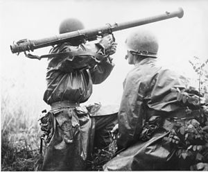 An American soldier (Robert L. Witzig) with a 2.36-inch bazooka prepares to take aim at a North Korean tank during the Battle of Osan. On his right is Kenneth R. Shadrick, who would later be reported as the first American killed in the Korean War.