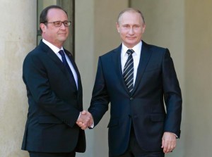 French President Francois Hollande, left, greets his Russian counterpart Vladimir Putin upon his arrival at the Elysee Palace in Paris, France, Friday, Oct. 2 , 2015. Russian President Vladimir Putin is meeting the leaders of Ukraine, France and Germany in a revived European push to bring peace to eastern Ukraine.The long-awaited summit in Paris on Friday is being overshadowed by international concerns about Russia’s military intervention in Syria this week.(AP Photo/Jacques Brinon) 