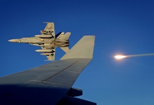 A Royal Australian Air Force F/A-18 Hornet strike fighter fires a flare while banking away from a RAAF KC-30A Multi-Role Tanker Transport aircraft over the skies over Iraq. *** Local Caption *** A Royal Australian Air Force KC-30A Multi-Role Tanker Transport aircraft enables Air Force to conduct air-to-air refuelling of Australian F/A-18A Hornets and other coalition aircraft over Iraq. Air-to-air refuelling is essential for ensuring Coalition aircraft can remain on-station for as long as possible to conduct or support close air support and precision strike operations in support of Iraqi Security Forces. The Air Task Group, part of Australias Operation OKRA, comprises six F/A-18 Hornet strike aircraft, a KC-30A Multi-Role Tanker Transport and an E-7A Wedgetail Airborne Early Warning and Control aircraft. They participate in air operations in Iraq and Syria as part of the international coalition formed to disrupt and degrade the Daesh threat.