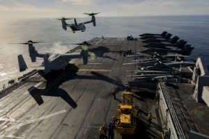PACIFIC OCEAN -- An MV-22B Osprey takes off from the flight deck of USS America (LHA 6), November 19, 2016. The Osprey dropped off distinguished visitors and media before the Lightning Carrier Proof of Concept Demonstration. The demonstration is the first shipboard Marine Corps F-35B integration demonstration alongside other Marine Corps Air Combat Element assets. (U.S. Marine Corps Photo by Cpl. Thor Larson/Released)