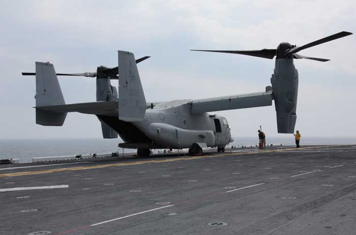 Flight deck crew members prepare an MV-22 Osprey with Marine Medium Tiltrotor Squadron 266, 26th Marine Expeditionary Unit, for take off during flight operations aboard USS Kearsarge, April 23, 2010. (Credit: 26th MEU)