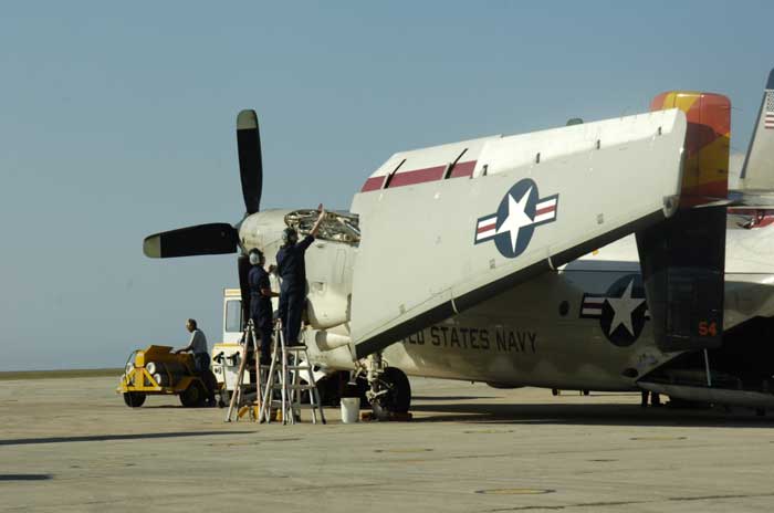 Maintenance personnel conduct routine maintenance to a C-2A Greyhound carrier onboard delivery aircraft at U.S. Naval Station Guantanamo Bay, Jan. 18. Service members from the Fleet Logistics Support Squadron were supporting Operation Unified Response, providing humanitarian assistance to Haiti. (Credit: USN Visual Service, 1/19/10)