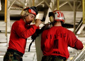 Aviation Ordnanceman 3rd Class Isaac Reyes (left) and Aviation Ordnanceman 2nd Class Charles Block prevent corrosion on an aircraft wing tip by performing daily maintenance checkups aboard USS Theodore Roosevelt (CVN 71). (Credit: USN Visual Service 1/15/09)