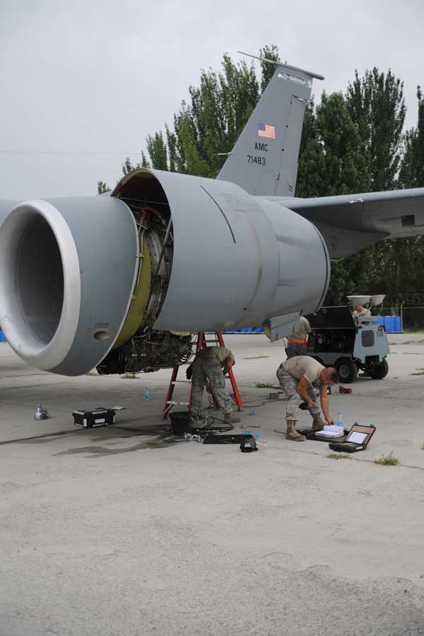 Airmen deployed from Fairchild Air Force Base, Wash., and Grand Forks AFB, N.D., perform maintenance operations on a KC-135 Stratotanker at the Transit Center at Manas, Kyrgyzstan on Aug. 6, 2010.  (Credit: Headquarters, Air Mobility Command Public Affairs)